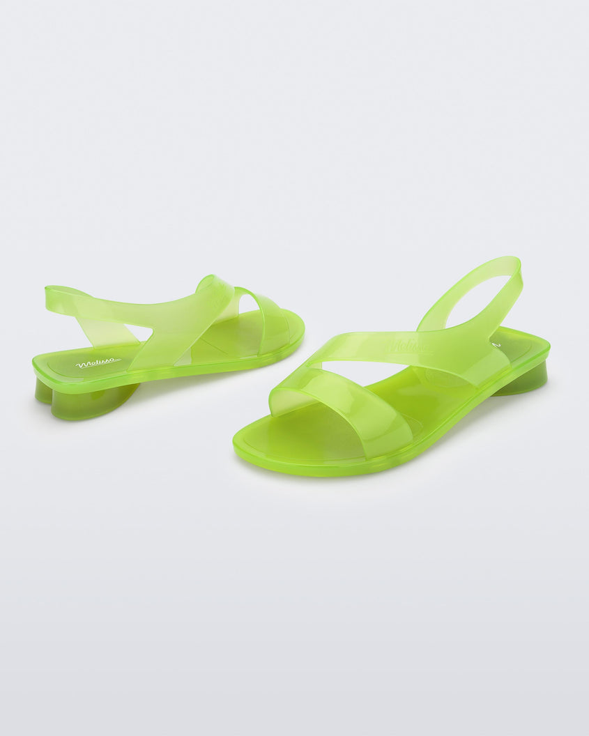 An angled side view of a pair of green Melissa The Real Jelly Paris sandals with two front straps and an ankle strap.