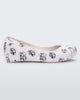 Side view of a white/grey Mini Melissa Ultragirl Cats & Dogs flat with a white base and cartoon dog face drawing pattern across the base.