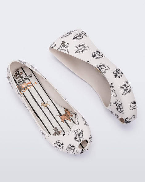 A top and side view of a pair of white/grey Mini Melissa Ultragirl Cats & Dogs flats with a white base and cartoon dog face drawing pattern across the base.