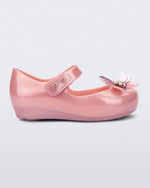 Side view of a pearly pink Mini Melissa Ultragirl Bugs flat with a top strap and a bug detail on the toe.