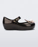 Side view of a metallic black Mini Melissa Ultragirl Bugs flat with a top strap and bug detail buckle on the toe.