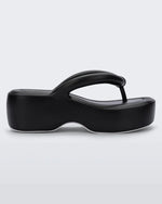 Side view of a pair of black Melissa Free Platform Flip Flops with puffer-like straps.