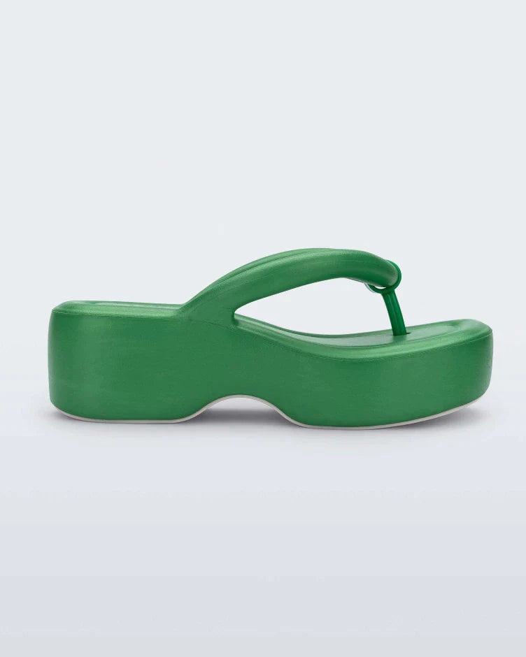 Side view of a green Melissa Free Platform flip flop with puffer-like straps.