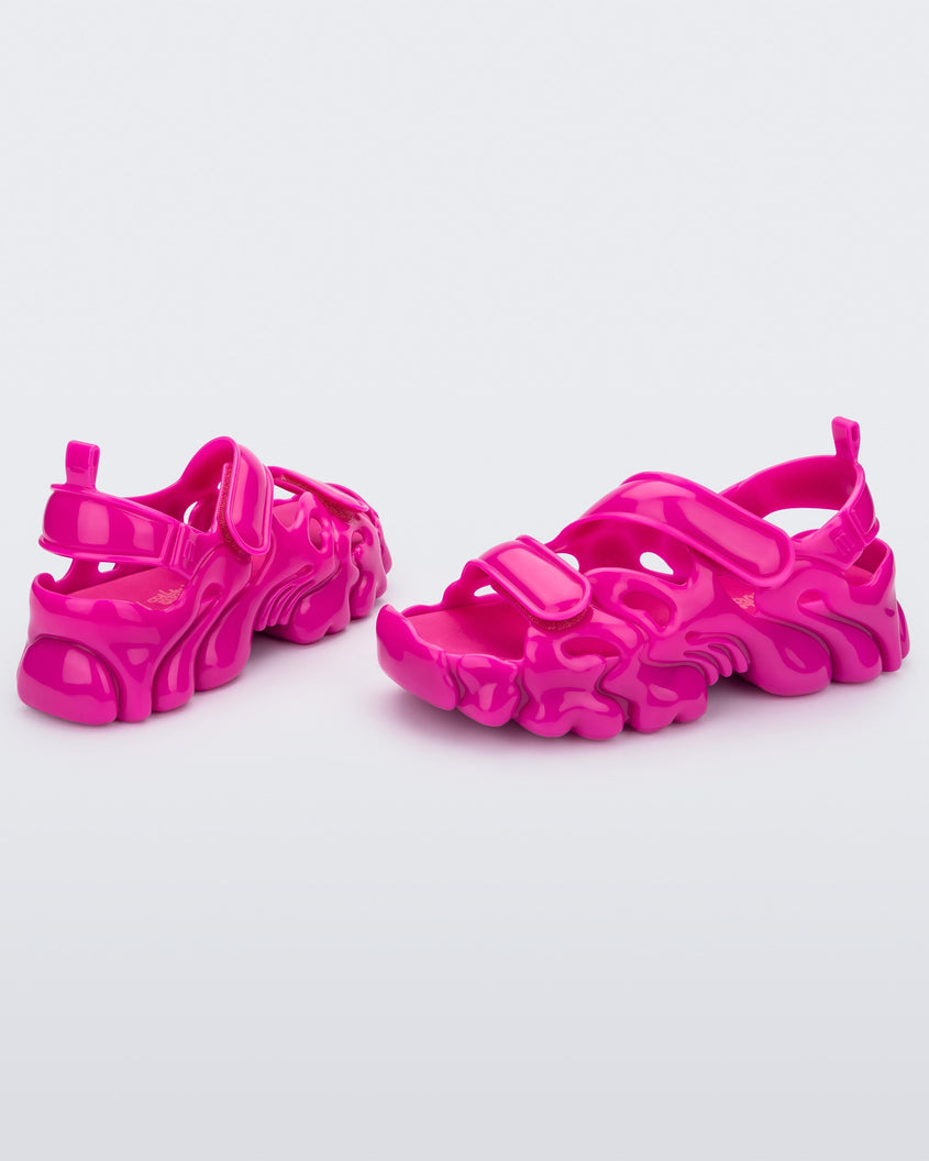 Angled view of a pair of Melissa Puff chunky sandals in pink with velcro straps