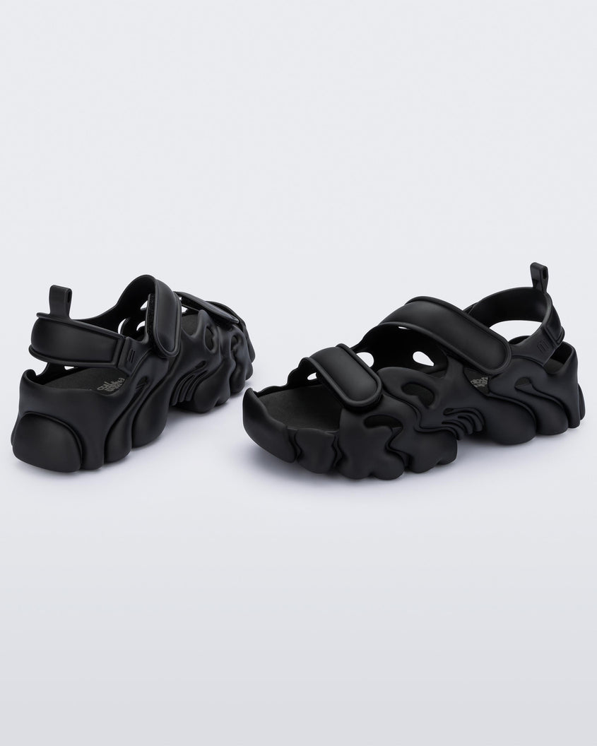 Angled view of a pair of Melissa Puff chunky sandals in black with velcro straps