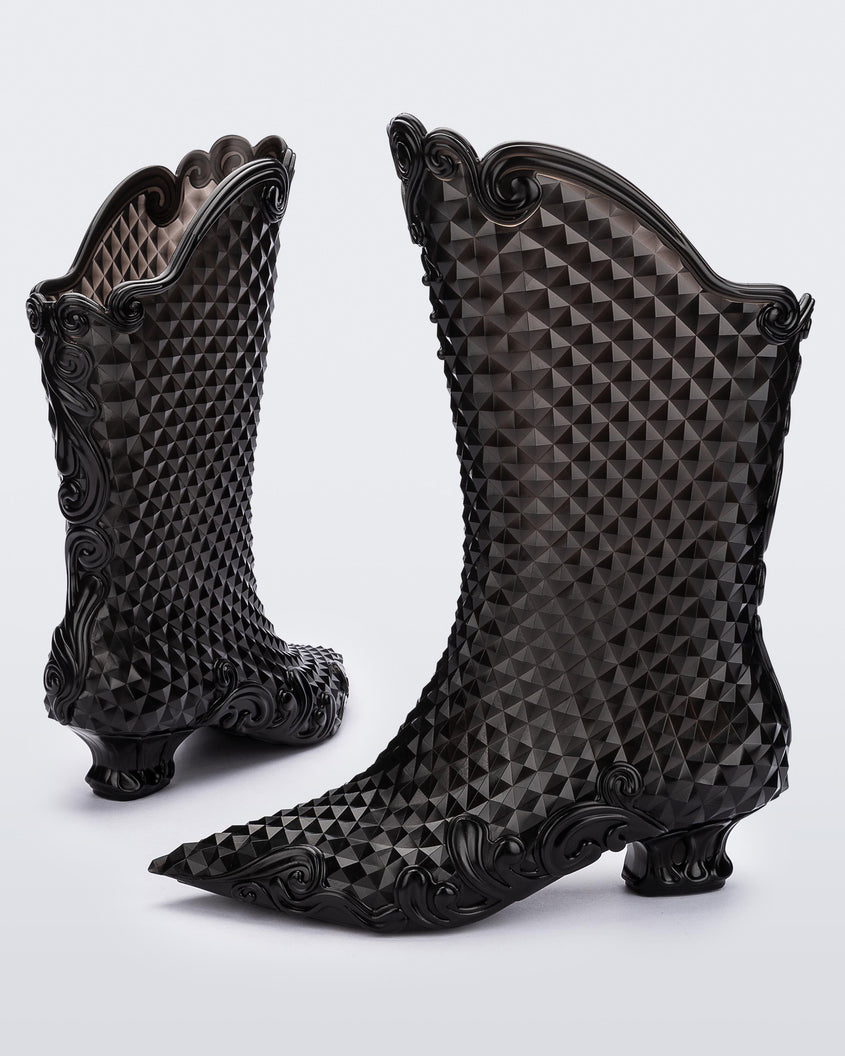 A back and side view of a pair of transparent black Melissa Court Boots with a short heel, heart detail on the front and a checkered pattern texture.