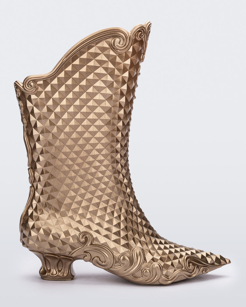 Side view of a metallic gold Melissa Court Boot with a short heel, heart detail on the front and a checkered pattern texture.