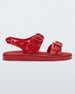 Side view of a red Melissa Spikes Sandal with two straps with buckles on top and spike details around the base.