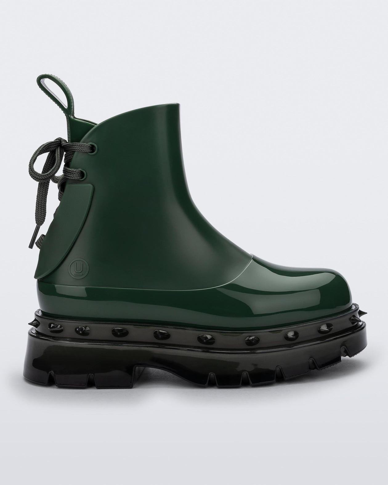 Side view of a green Melissa Spikes Boot with spike details around the sole and laces in the back.