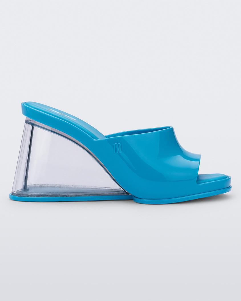 Side view of a blue Melissa Darling heel with a clear sole.
