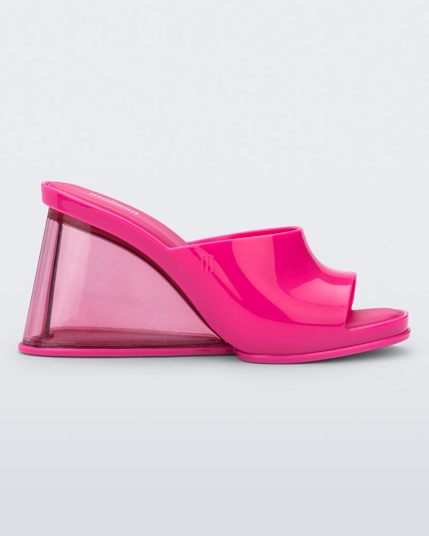 Side view of a pink Melissa Darling heel with a clear sole.