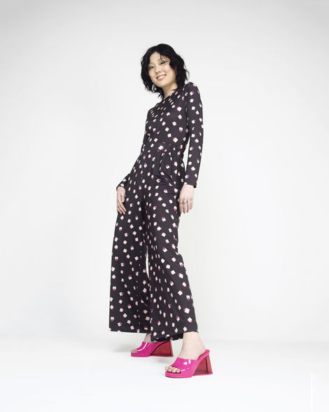 A model posing for a picture wearing a pair of pink Melissa's Darling heels with clear soles.