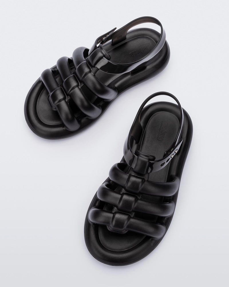 Top view of a pair of black Melissa Freesherman sandals with black and clear straps.