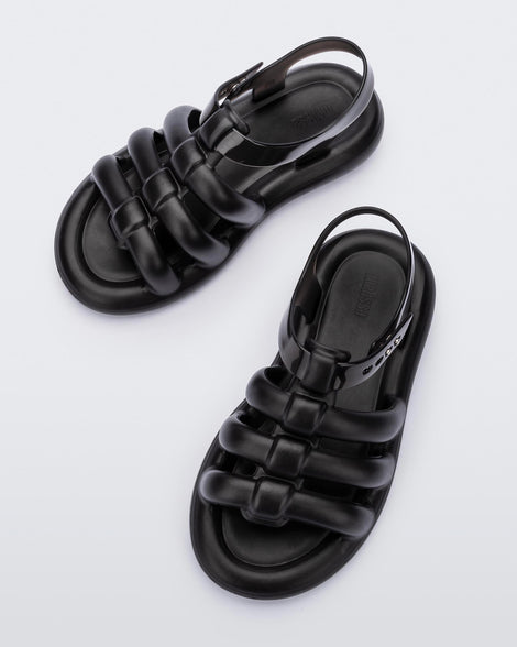 Top view of a pair of black Melissa Freesherman sandals with black and clear straps.