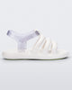 Side view of a white Mini Melissa white sandal with white and clear glitter straps.