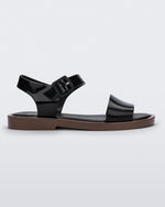 Side view of a black/brown Melissa Mar sandal with two black straps and a brown sole.