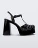 Side view of a black Melissa Party Heel with several straps and a closed toe front.