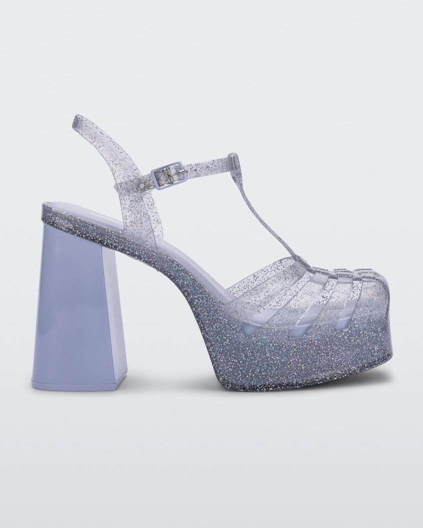 Side view of a glitter clear Melissa Party Heel with several straps and a closed toe front.