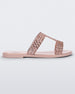 Side view of a pink / rose Melissa Glowing slide with pink gem stones on the straps and a pink sole.