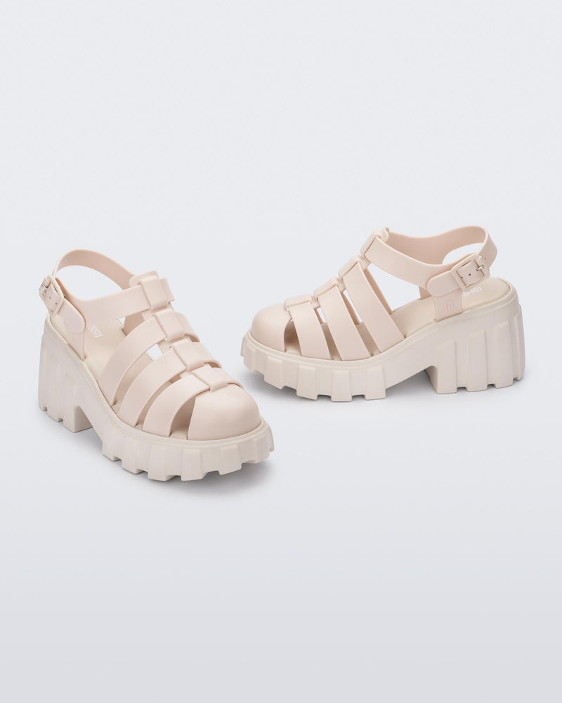 Angled view of a pair of beige Melissa Megan platform heel sandals.