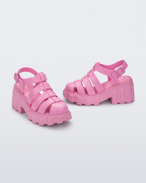 Angled view of a pair of pink Melissa Megan platform heel sandals.