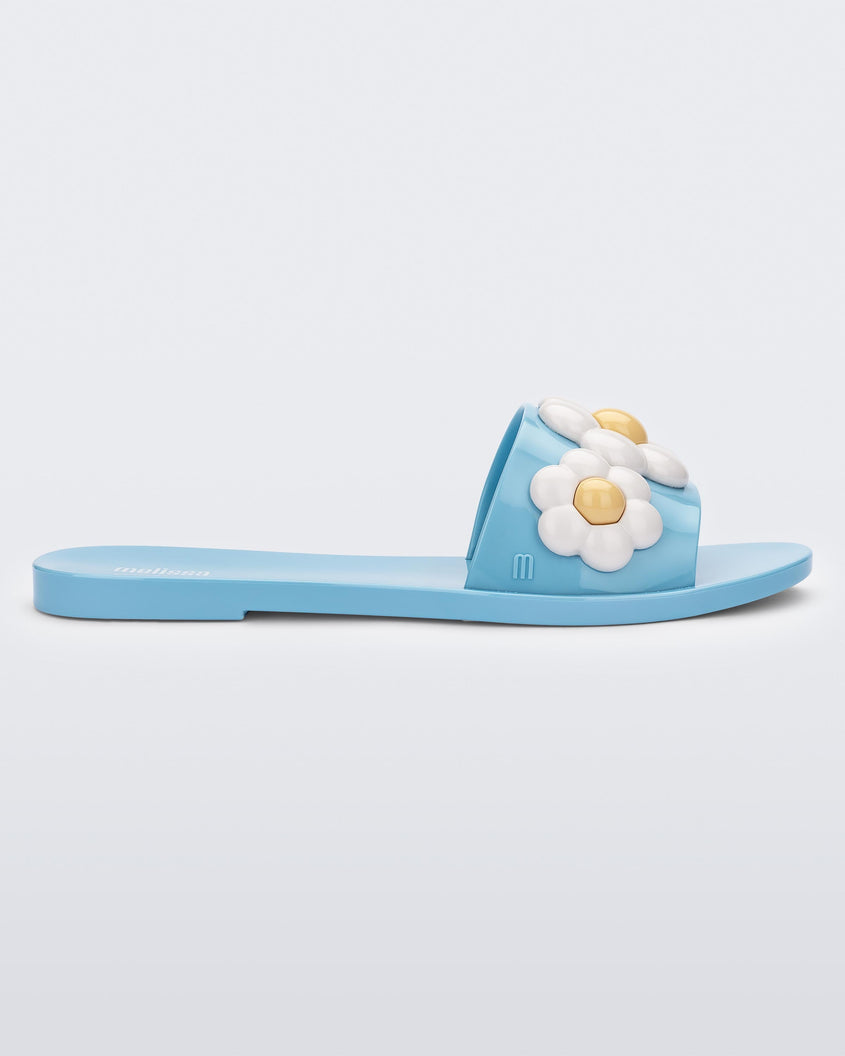 Side view of blue Melissa Babe Spring slide with white flowers.