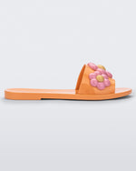 Side view of orange Melissa Babe Spring slide with pink flowers.