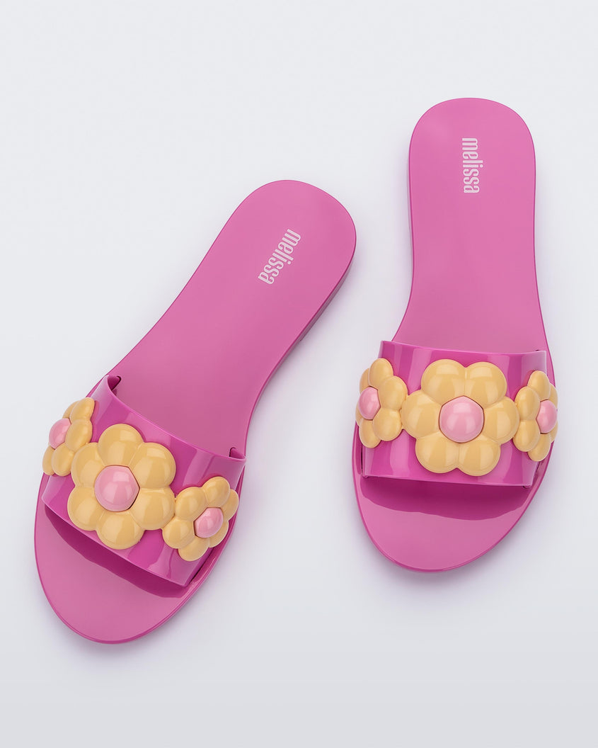 Top view of a pair of purple Melissa Babe Spring sandals with yellow flowers.