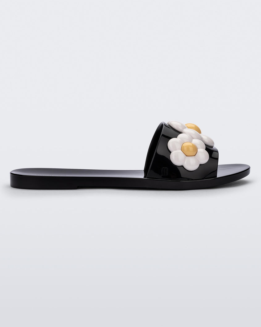 Side view of black Melissa Babe Spring slide with white flowers.