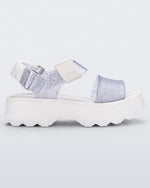 Side view of a white/glitter clear platform Melissa Kick Off Sandal with two glitter straps.