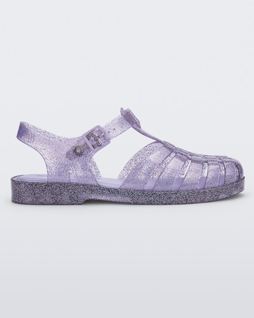 Side view of a glitter lilac Melissa Possession sandal with several straps and a closed toe front.