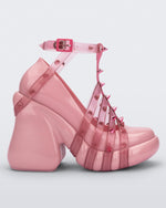 Side view of a pink/transparent Melissa Punk Love Heel with pink straps fastening at a top ankle strap with spike details.