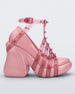 Side view of a pink/transparent Melissa Punk Love Heel with pink straps fastening at a top ankle strap with spike details.