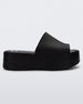 Side view of a black Melissa Becky platform slide with the marc jacobs logo across the sole.