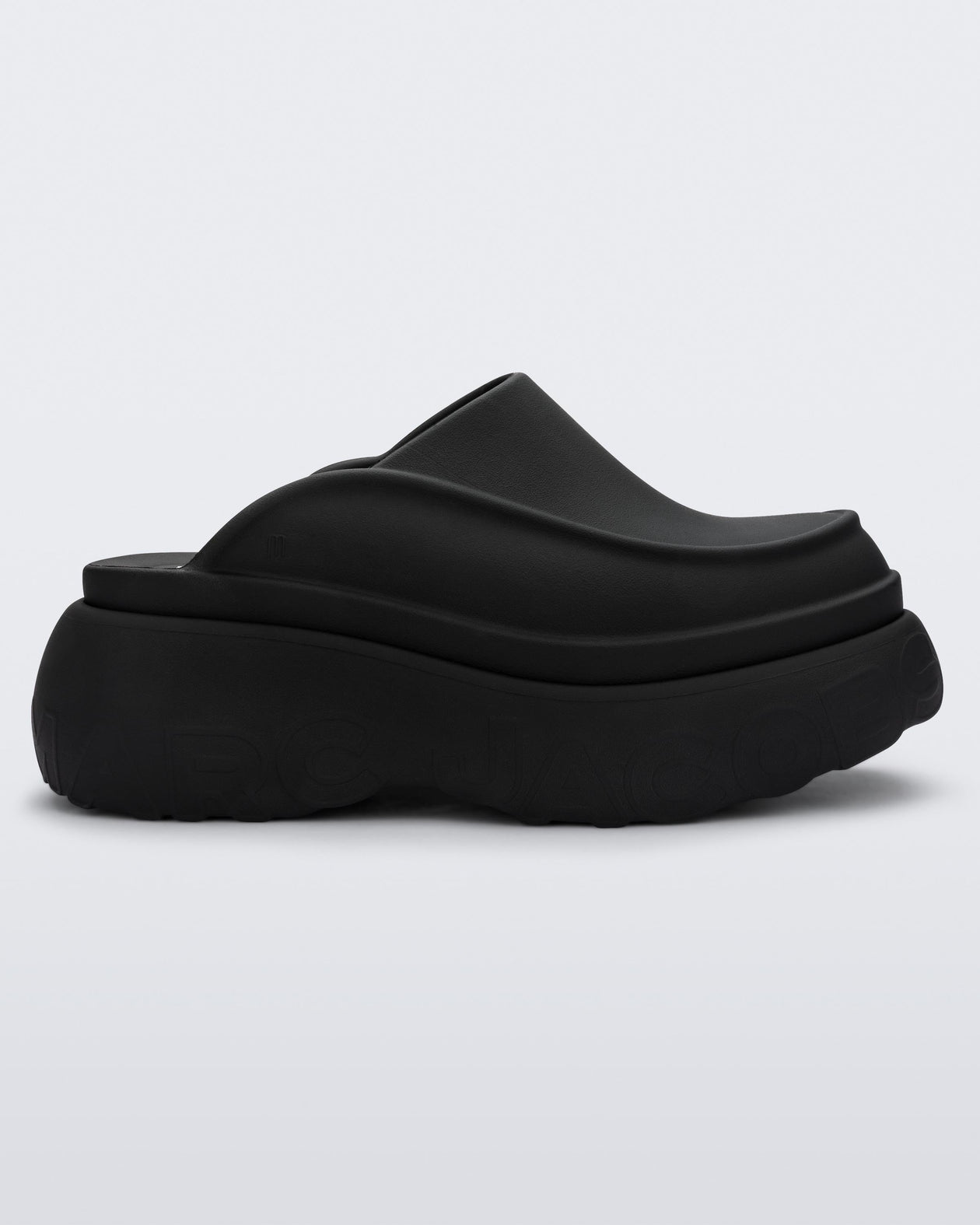 Side view of a black Melissa Clog with the Marc Jacob's logo across the sole.
