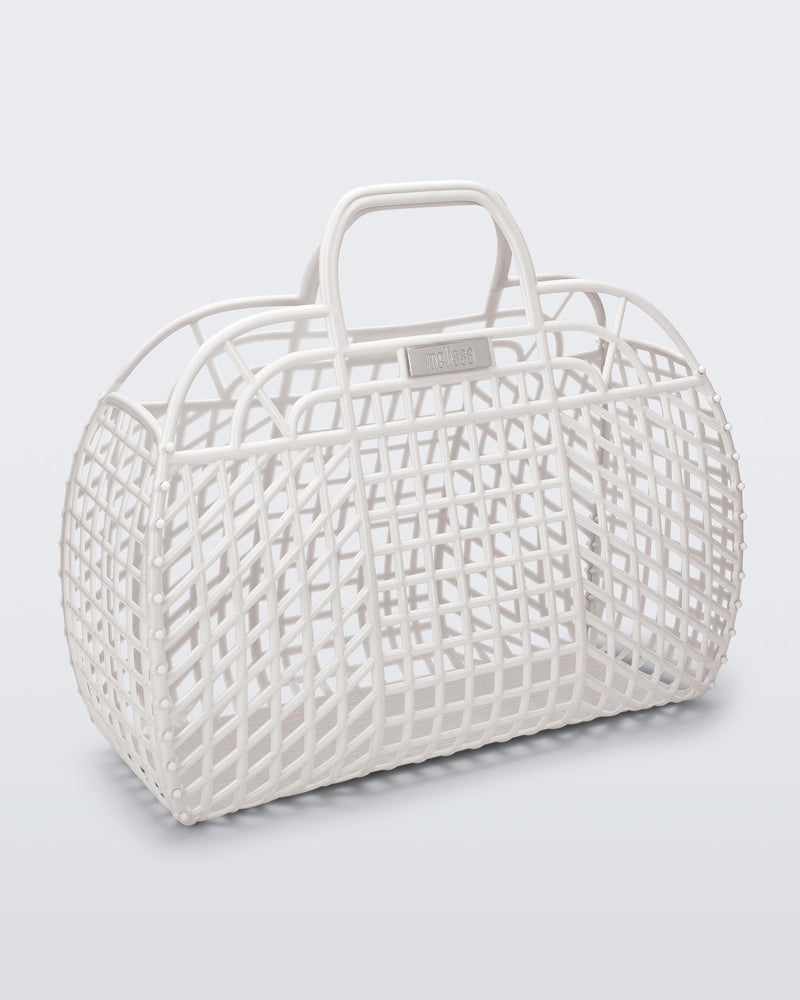 Angled view of a white Refraction bag with handles
