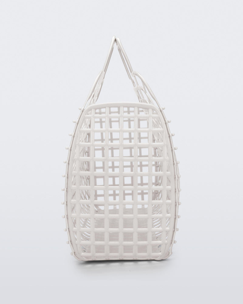 Side view of a white Refraction bag with handles