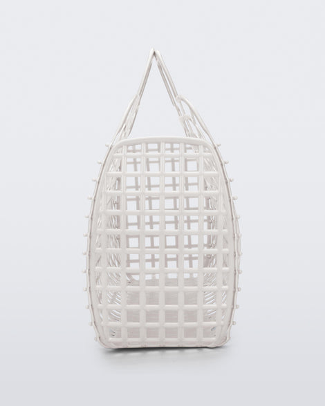 Side view of a white Refraction bag with handles