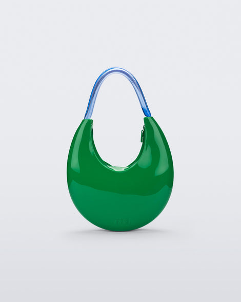 Front view of a Green/Blue Melissa Moon Bag with a crescent shaped green bag base and a blue beige top strap.