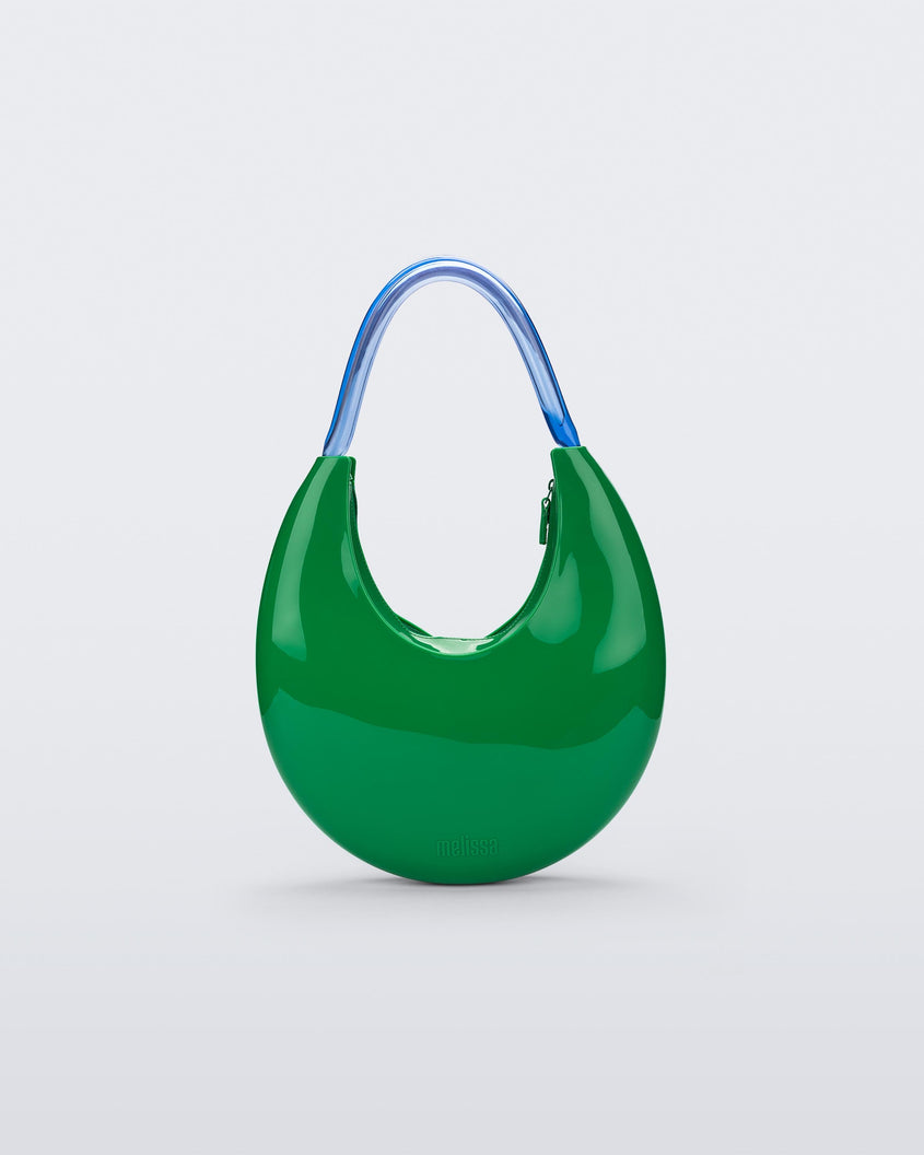 Front view of a Green/Blue Melissa Moon Bag with a crescent shaped green bag base and a blue beige top strap.