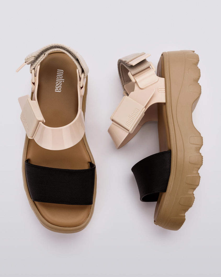 A top and side view of a pair of Beige/Black Melissa Kick Off Platform Sandals with a brown sole and two black and tan straps.