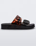 Side view of a Black/Clear Tortoise Melissa Cozy slide with two black and transparent tortoise straps with a buckle detail.
