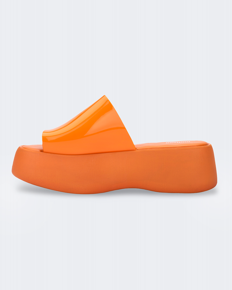 Inside view of an orange Melissa Becky platform slide. 