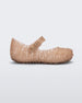Side view of Mini Melissa Campana beige glitter flats with a snap strap for baby with an open woven texture