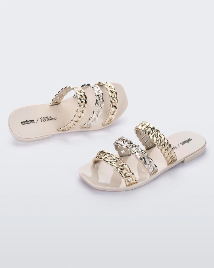 A top and side view of a pair of white Melissa Feel slides with three gold and silver chain detail straps.