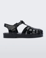 An outter side view of a black Mini Melissa Possession sandal with several straps and a black base.