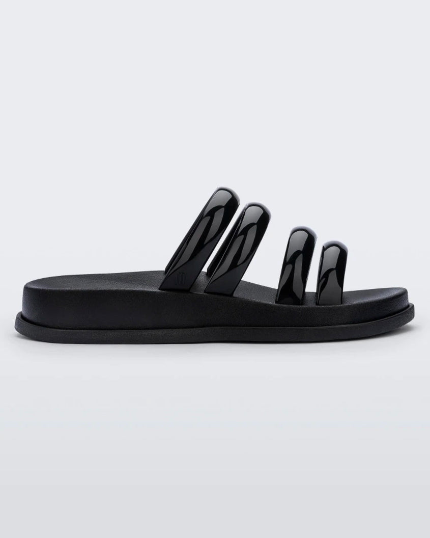 Side view of a Black Melissa Soft Wave Slide with 4 front straps.