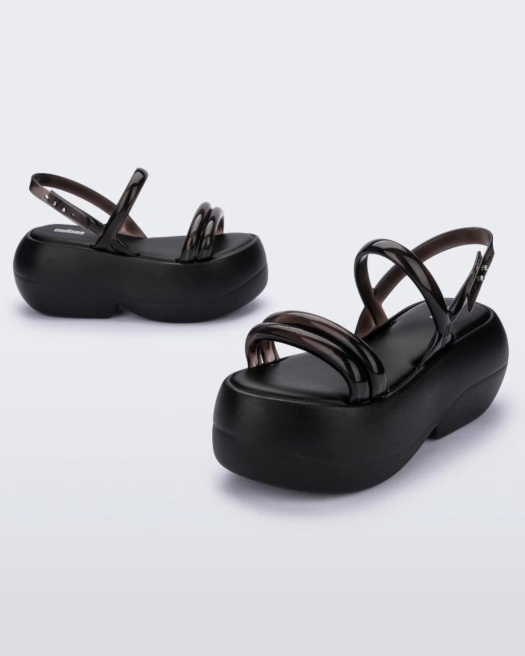 Side view of a pair of black Melissa Airbubble Platform sandals.
