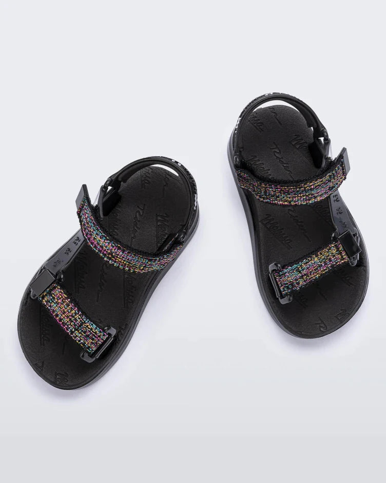 Top view of a pair of black Mini Melissa Papete sandals with glitter and black straps.