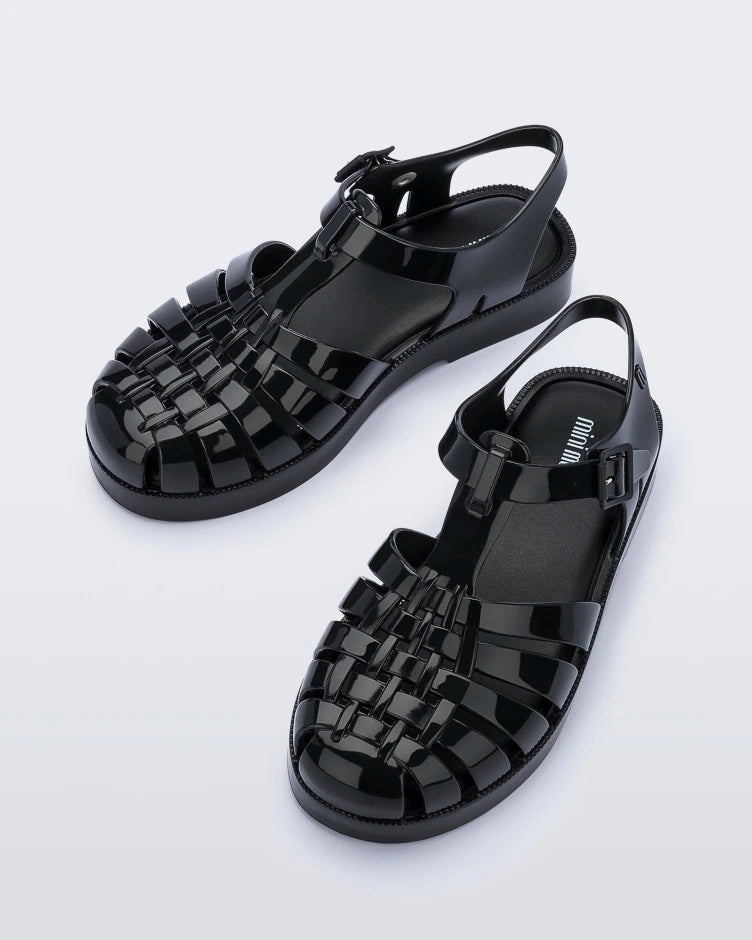 Top view of a pair of black Mini Melissa Possession sandals with several straps and a black base.